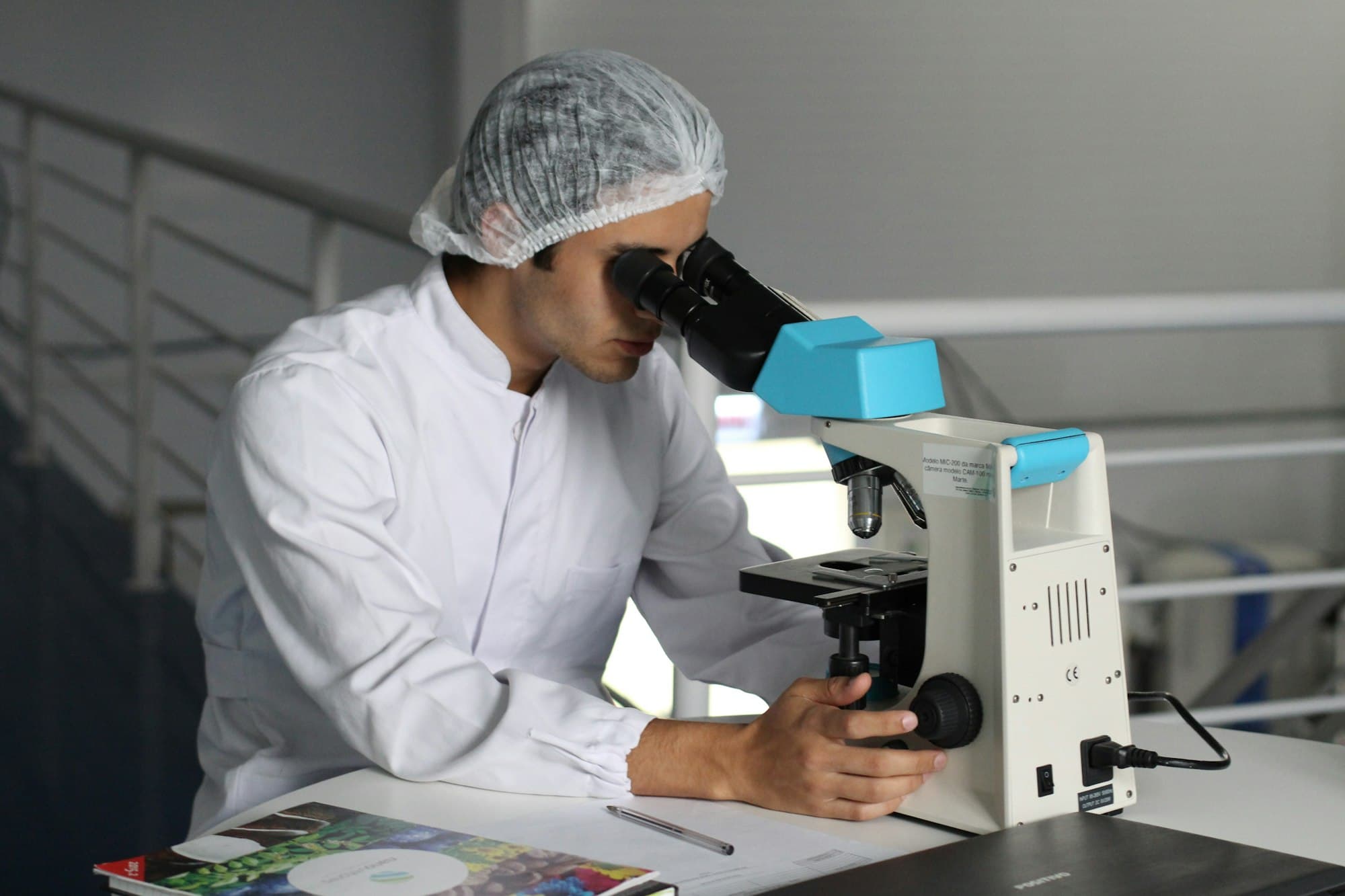 A scientist looking through a microscope